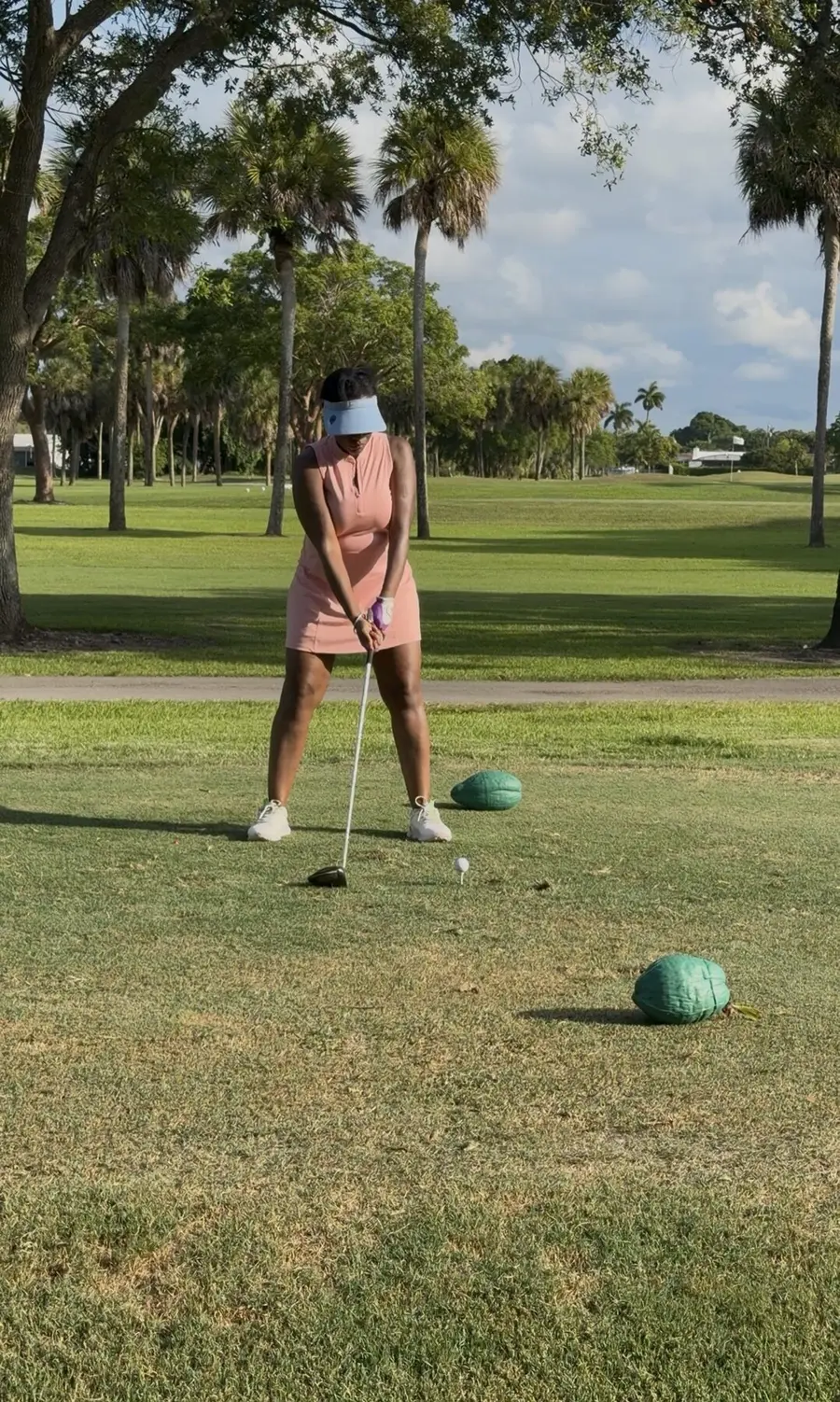 Sharonda teeing off on a sunny golf course