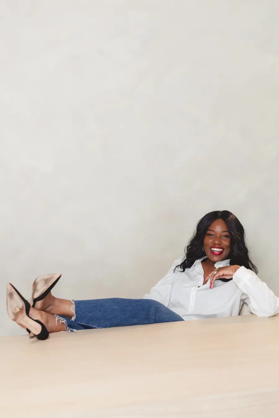 Sharonda relaxing with her feet up, smiling