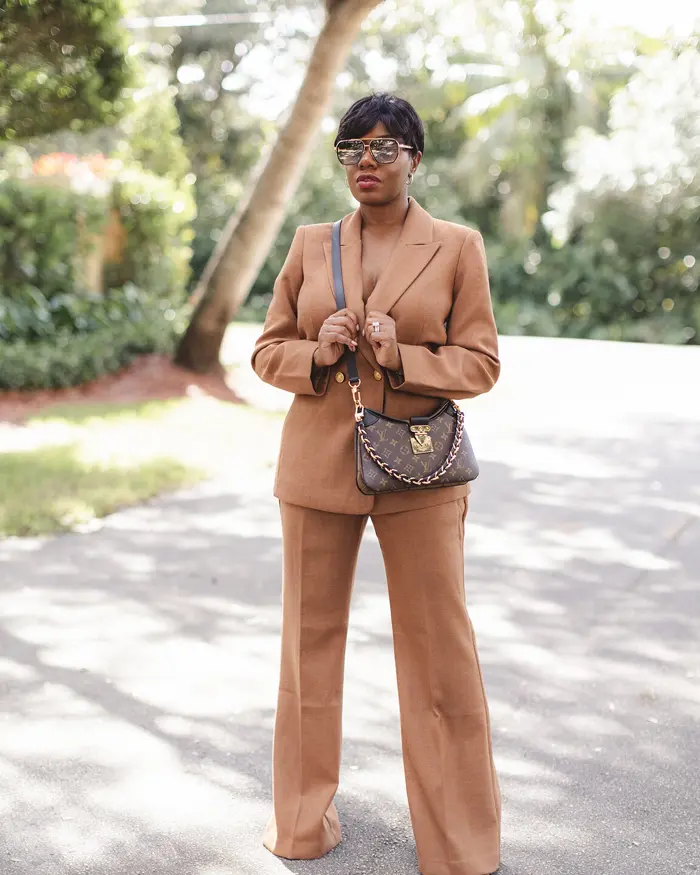 Sharonda in a camel trouser suit and sunglasses
