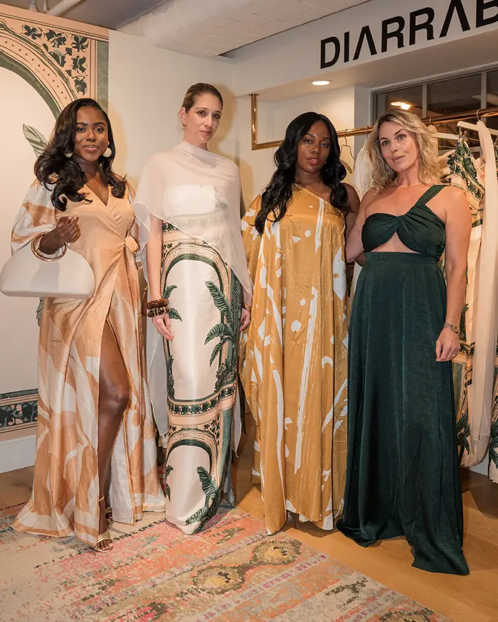 Sharonda and friends in flowing gowns at a fashion event
