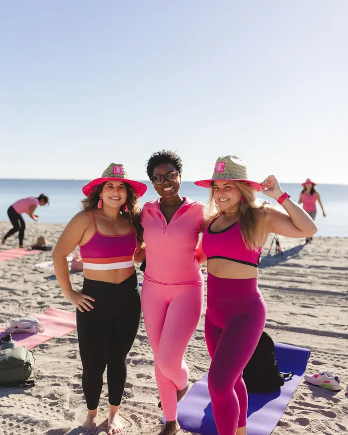 Sharonda and friends in pink at a beach yoga session