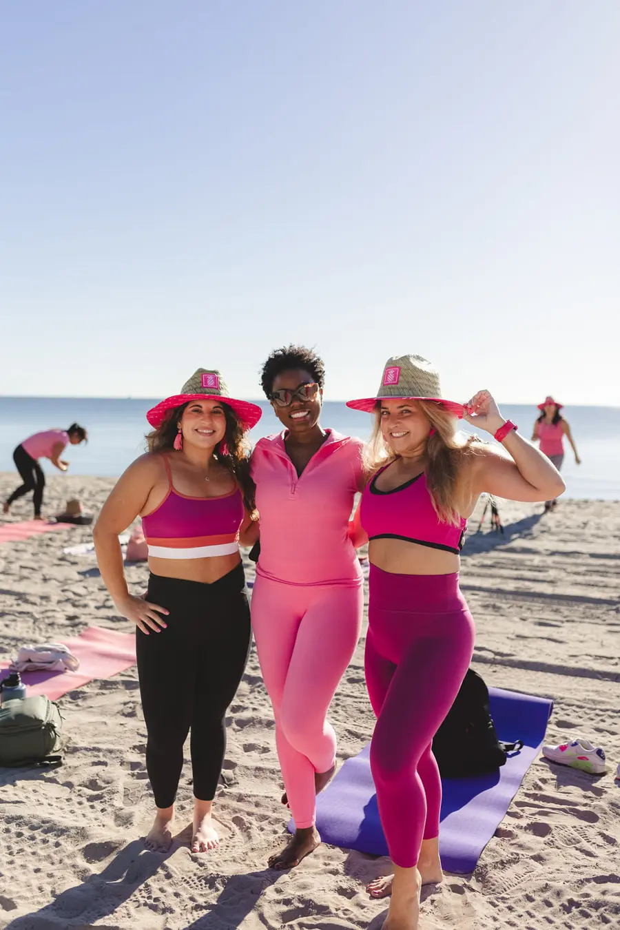 Sharonda and friends in pink at a beach yoga session